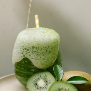 Kiwifruit vinegar drink being poured over crushed kiwifruit