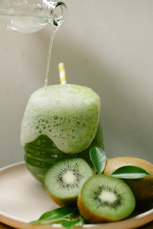 pexels-photo-8679374-1.jpeg Kiwifruit vinegar drink being poured over crushed kiwifruit